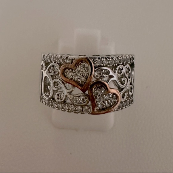 Jewelry - Beautiful engagement steinless steel ring with two cooper color hearts .